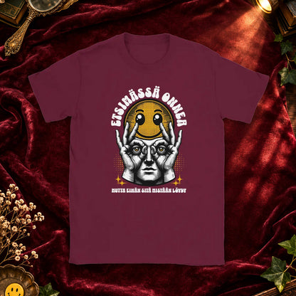 T-shirt featuring a worried character holding a smiley face beside the Finnish words Etsim�ss� onnea.