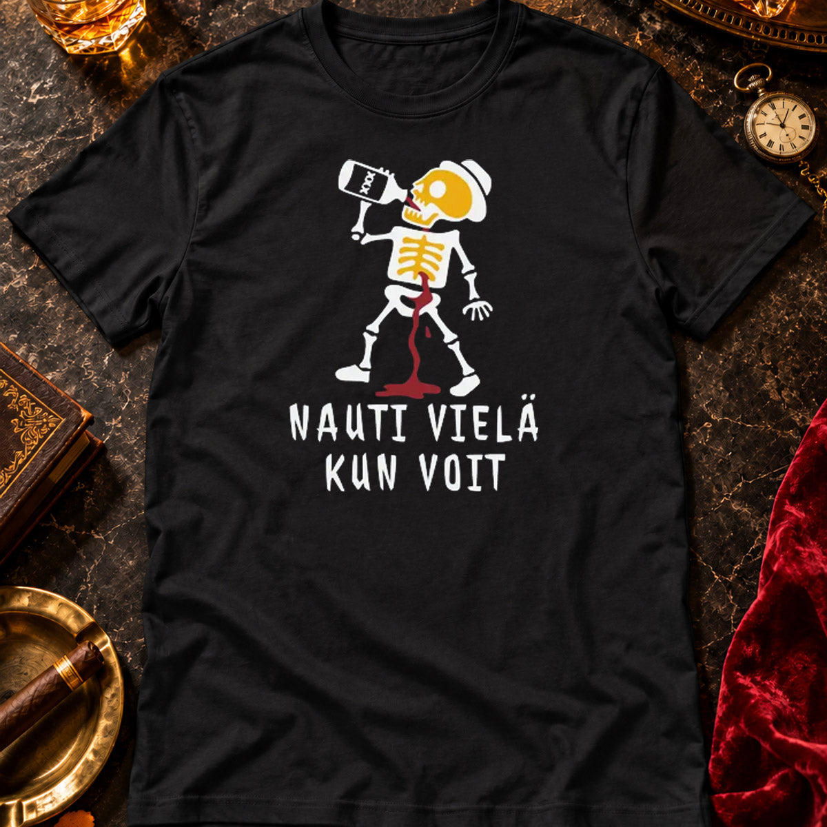 T-shirt featuring a skeleton drinking from a bottle beside the Finnish words NAUTI VIEL� KUN VOIT.