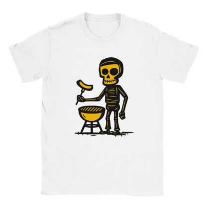 White T-shirt featuring a skeleton beside a round barbecue holding a sausage on a grilling fork.