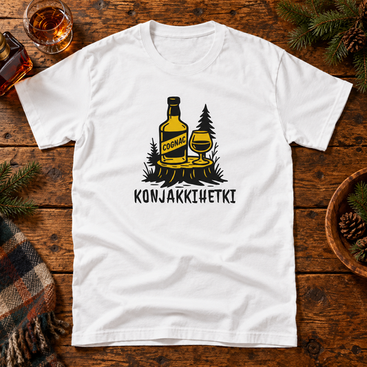 White Konjakkihetki T-shirt on a rustic table with a cognac glass and woodland props.