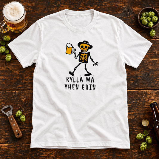 White Kyllä Mä Yhen Ehin T-shirt with a skeleton holding a beer mug on a wooden pub table, surrounded by a foamy beer and hops.
