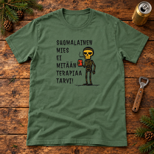 Military green Finnish skeleton slogan T-shirt on a cabin table with a beverage can, bottle opener and pine sprigs.